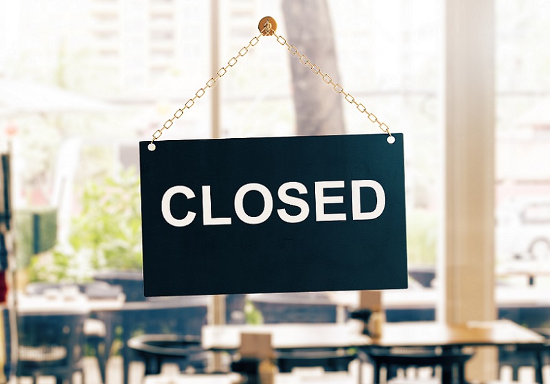 Empty restaurant with closed sign due to coronavirus and in breach of commercial lease agreement