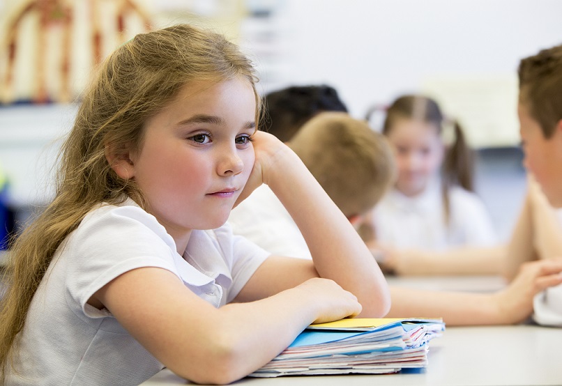 School-aged girl sitting at desk with files for family law matter