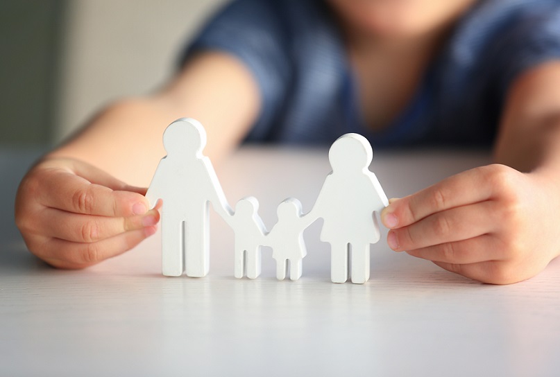 Child holding paper chain of family during coronavirus parenting issues