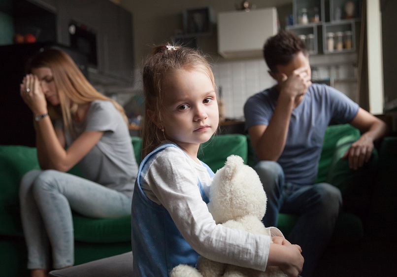 Parents disagreeing over their family court matter during the coronavirus pandemic with their young daughter in the foreground